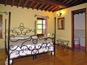 a bedroom with a metal bed in a room at Podere Caldaruccio La Pineta in Bosco