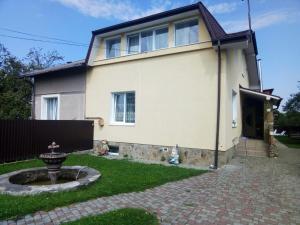 a house with a brick yard in front of it at Prykarpatska Villa in Morshin