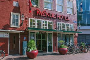 a red brick building with a bicycle parked in front of it at Avenue Hotel in Amsterdam