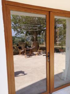 a glass door with a reflection of a patio at La Bastide du Limon in Mormoiron