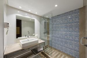 a bathroom with a sink and a mirror at Iberostar Selection Kuriat Palace in Monastir