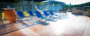 a group of chairs and tables on a patio at Apollonia Hotel Apartments in Varkiza