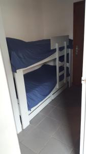 a bedroom with a bunk bed with blue sheets at les Huniers Appt 1er étage in Arcachon
