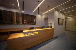 a lobby with a reception desk in a building at City Center Hotel in Tirana