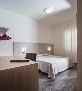 A bed or beds in a room at Alfa Fiera Hotel