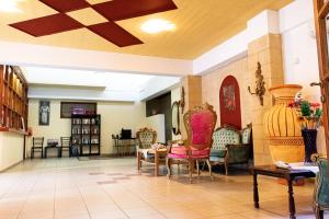 a living room with chairs and a table at ZagaMilos Hotel in Koroni