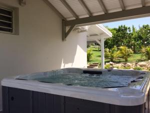 a hot tub in the corner of a house at Villa Natur Dylis in Saint-François