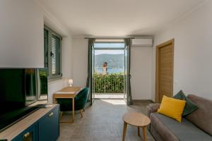a living room with a couch and a view of the ocean at Boka Apartment 4 in Herceg-Novi
