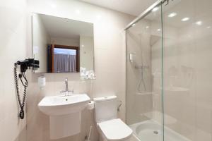 a bathroom with a shower, toilet and sink at Portofino Mallorca in Palma de Mallorca