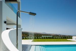 The swimming pool at or close to Vilana White Elegant Villa