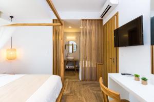 A bed or beds in a room at Vilana White Elegant Villa
