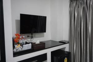 a living room with a tv on a wall at Heaven Apartments in Patong Beach