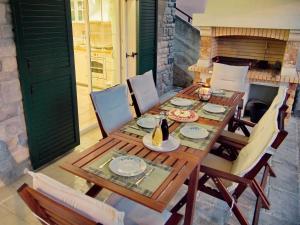 a wooden table and chairs on a patio at VILLA MATIJA in Cesarica