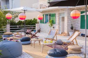 a patio with chairs and tables and an umbrella at Villa Astra in Brela
