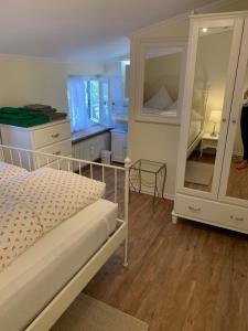 sypialnia z łóżkiem, komodą i lustrem w obiekcie Ferienwohnung Giacomelli 3 w mieście Rottach-Egern