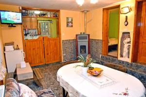 a living room with a table and a tv at House By The River in Teteven