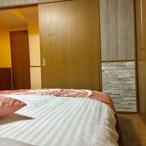 1 dormitorio con cama y pared de piedra en LaForet inn 303 , en Hiroshima