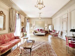 a living room with a couch and a table at Le Meurice – Dorchester Collection in Paris