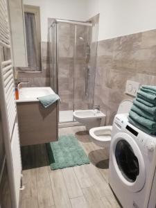 a bathroom with a washing machine and a washer at La casa di Angio c cir D1135 in Lanzo dʼIntelvi