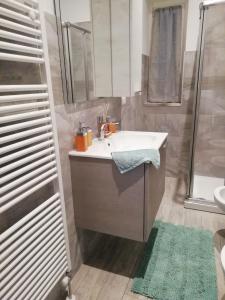 y baño con lavabo blanco y ducha. en La casa di Angio c cir D1135, en Lanzo d'Intelvi
