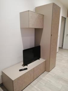 a living room with a flat screen tv on a cabinet at La casa di Angio c cir D1135 in Lanzo dʼIntelvi