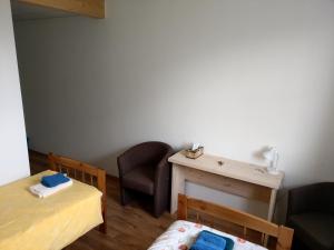 Habitación con 2 camas, escritorio y silla. en Kresto en Mäo