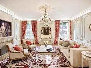 a living room with a couch and a table at Le Meurice – Dorchester Collection in Paris
