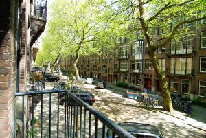 a view from a balcony of a street with buildings at Wooden Mill B&B in Amsterdam