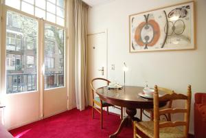a dining room with a table and a window at Wooden Mill B&B in Amsterdam