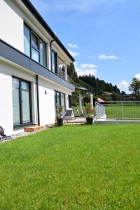 une maison avec une pelouse devant elle dans l'établissement Ferienhaus Lurger, à Strassen