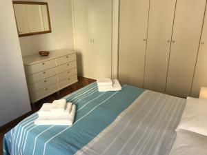 a bedroom with a bed with towels on it at Casavacanze estate 3 in San Benedetto del Tronto