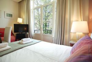 a bedroom with a white bed and a window at Wooden Mill B&B in Amsterdam