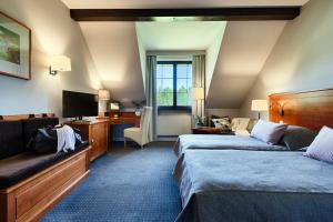 Postel nebo postele na pokoji v ubytování Hotel SPA Dr Irena Eris Wzgórza Dylewskie + 37 fotografií