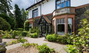 an exterior view of a house with a garden at The Firs in Bowness-on-Windermere