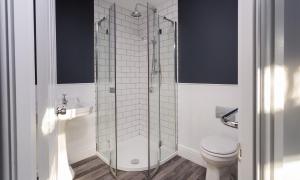 a bathroom with a glass shower with a toilet at The Firs in Bowness-on-Windermere +26 photos