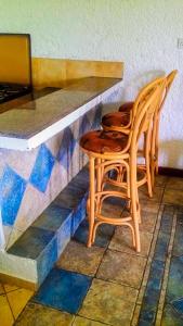 two chairs sitting next to a counter in a restaurant at Kianderi Villa-Great Rift Valley Resort in Naivasha