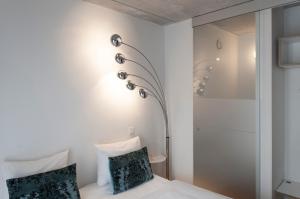 a hotel room with a bed and a lamp at Hotel Banks in Antwerp