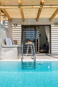 a patio with a table and a swimming pool at Ktima Fabiatos in Skala
