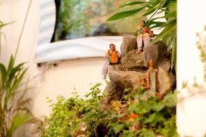 two dolls sitting on a rock in a garden at Juzz Holiday Lets in London