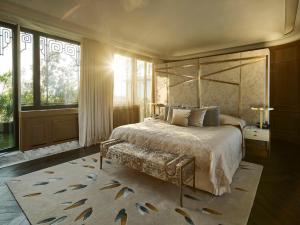a bedroom with a large bed and a rug at Le Meurice – Dorchester Collection in Paris