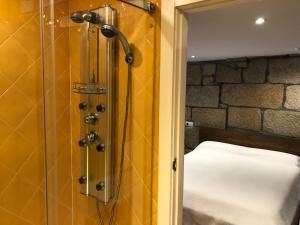 a bathroom with a shower with a bed in it at Casa Boutique Marín 1910 in Marín