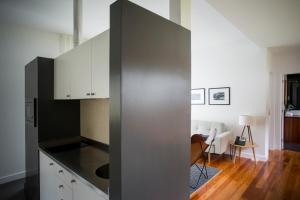 a kitchen with white cabinets and a black counter top at Furnas Lake Forest Living in Furnas