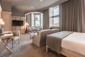 a hotel room with a bed and a desk at The Scotsman Hotel in Edinburgh