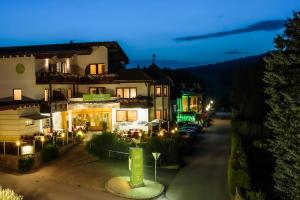 a building with a sign in front of it at night at VitalZeit Hotel Weber in Bad Schönau