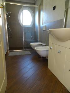 uma casa de banho com um chuveiro, um WC e um lavatório. em Casa Costa Outlet 5 em Serravalle Scrivia
