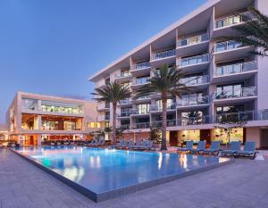 a swimming pool in front of a building at Zota Beach Resort in Longboat Key