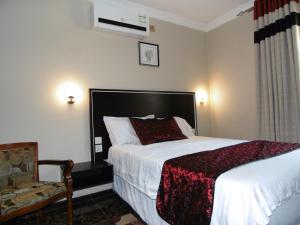 En eller flere senge i et værelse på Annavilla7 Lilongwe Aparthotel