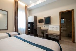 A bed or beds in a room at San Lorenzo - Boutique Hotel & SPA