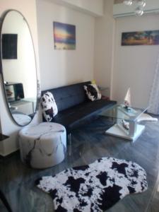 a living room with a black couch and a mirror at Tony Central Luxury Apartment 1 in Chania