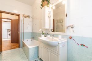 a bathroom with a sink and a bath tub and a sink at 4 Star Family & Friends Apt - Self Check-in in Bologna +79 photos